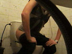 Teenage babe emptying her bladder in public toilet